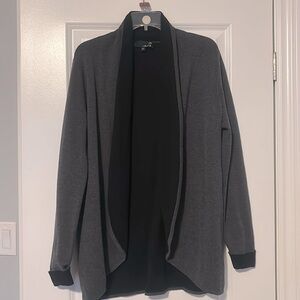 Laura large grey sweater with black detail.